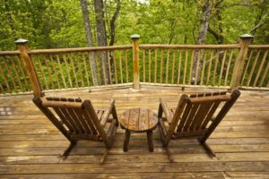 Cabin porch with chairs.