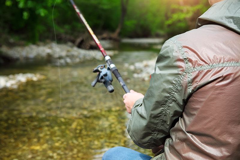 A man fishing in a stream.