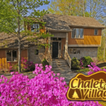 Beautiful pink flowers in front of a cabin at Chalet Village in Gatlinburg TN.