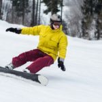 A man snowboarding down a slope.