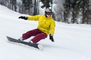 A man snowboarding down a slope.