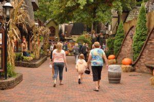 A family walking through The Village in Gatlinburg.