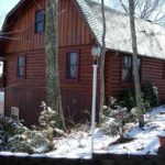 A log cabin in Gatlinburg covered in snow.