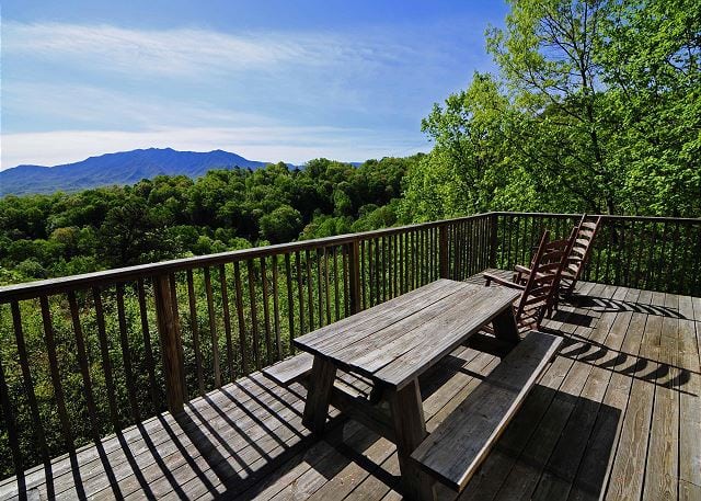 The deck of a Gatlinburg cabin with mountain views.