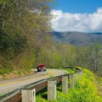A car driving along Newfound Gap Road in the Smoky Mountains.