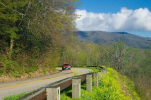 A car driving along Newfound Gap Road in the Smoky Mountains.