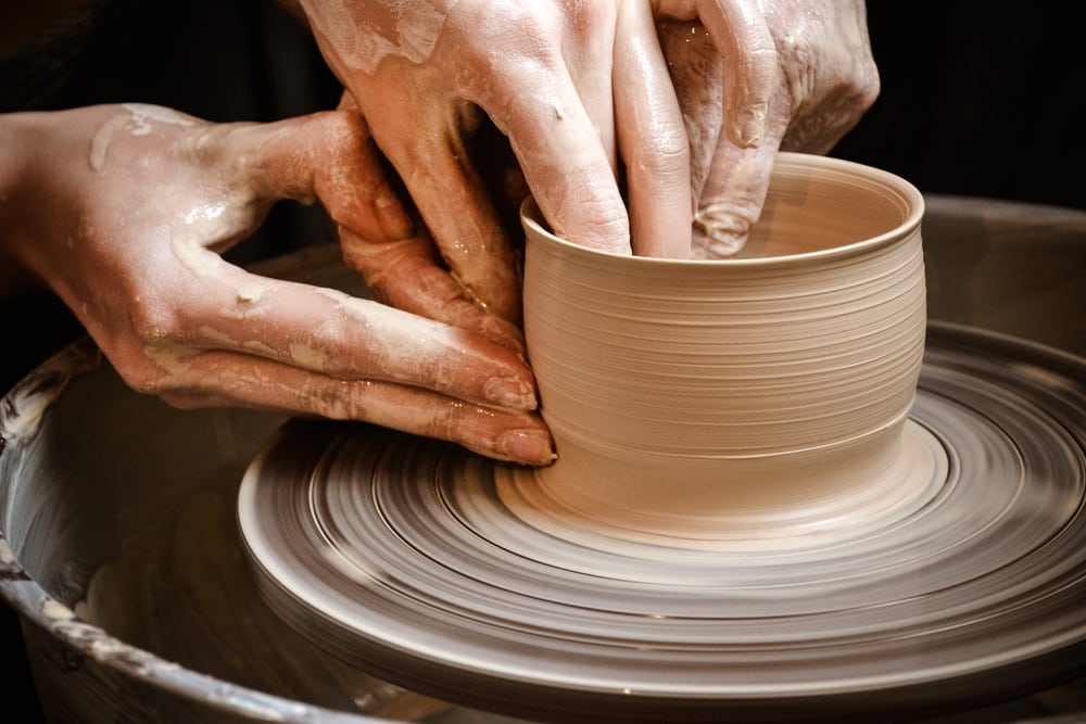 person making pottery