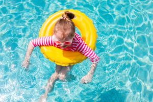 little girl in an inner tube in a pool